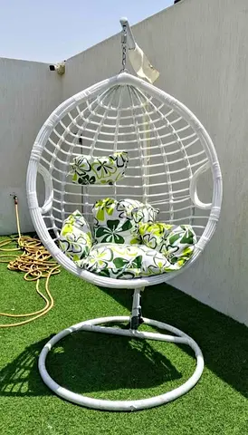 White Rattan Hanging Egg Chair with Green Floral Cushions