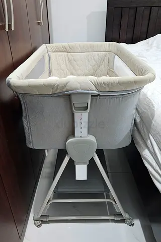 Light grey bedside bassinet with storage shelf - good condition