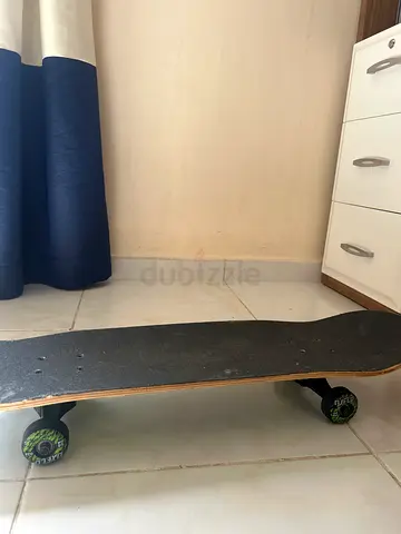 Used standard skateboard with grip tape and graphic wheels - good condition