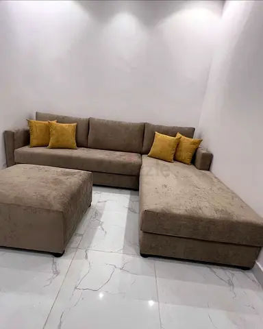 L-shaped beige fabric sofa with ottoman - good condition