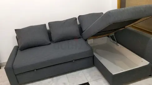 Ikea Gray L-shaped sofa with storage and pull-out bed