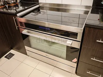 Large induction cooking range with electric oven — excellent condition
