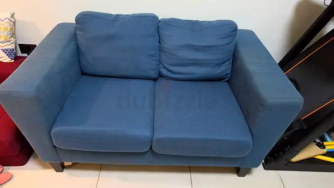 Blue two-seater fabric sofa in good used condition