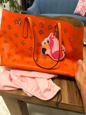 Kate Spade orange perforated tote bag with flamingo charm, gently used