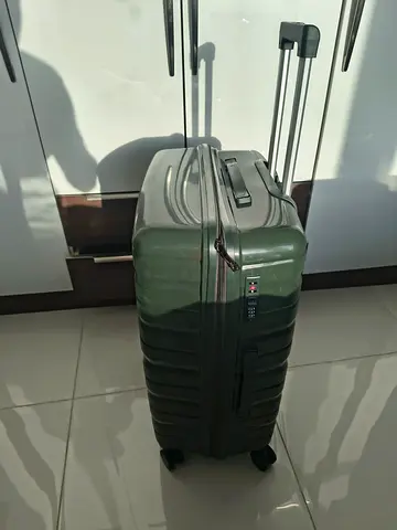 Green hard-shell large suitcase with spinner wheels