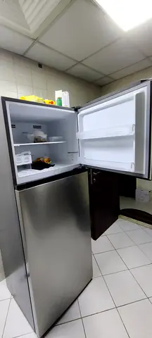 Compact stainless steel top-freezer refrigerator - good condition