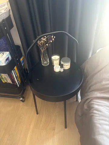 Small black metal side table with raised rim - good condition