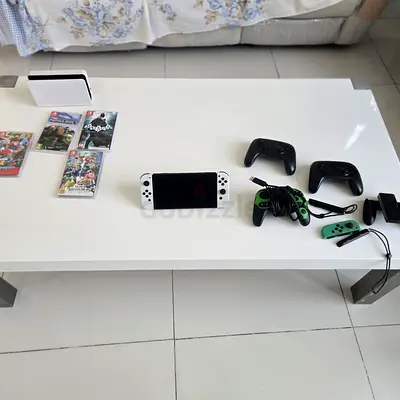 Nintendo Switch OLED with 5 switch games and 3 controllers