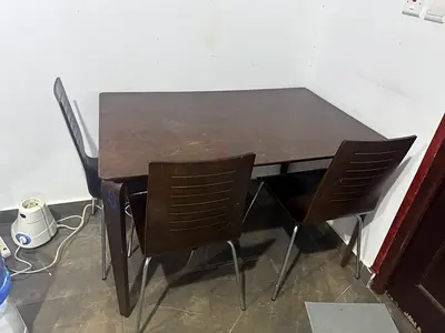 Used dark wood dining table with 4 chairs - compact set