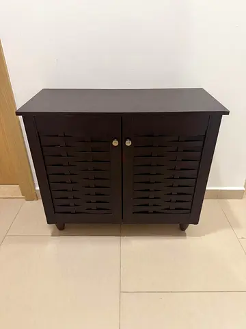 Compact dark wood storage cabinet with louvered doors- shoe rack