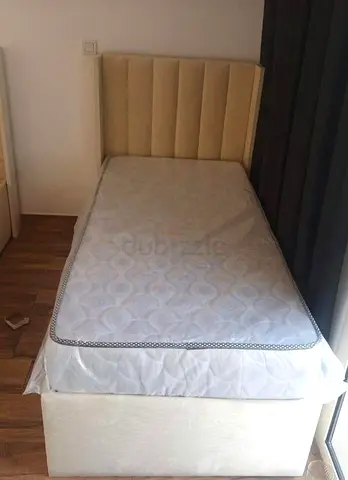 Single bed with upholstered headboard and storage base — good condition