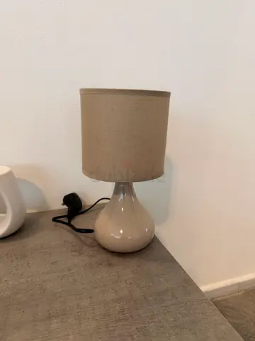 Small beige ceramic table lamp with fabric shade