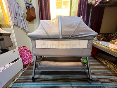 Gray Baby Bassinet with Canopy, Wheels and Storage Shelf