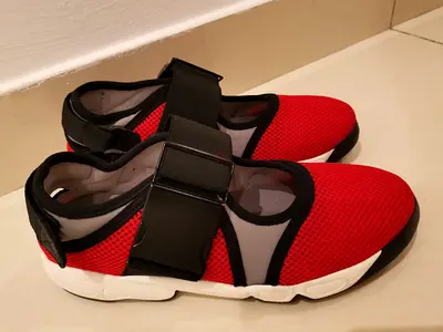 Red slip-on athletic sneakers with adjustable straps, never used