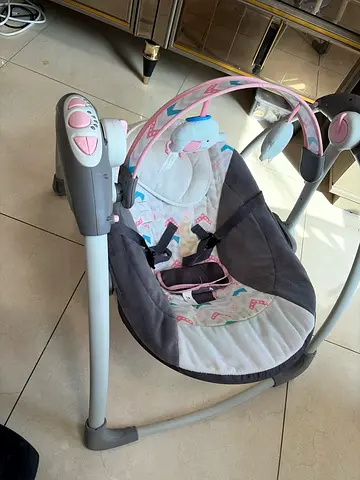 Baby swing rocker with music and toy bar - good condition