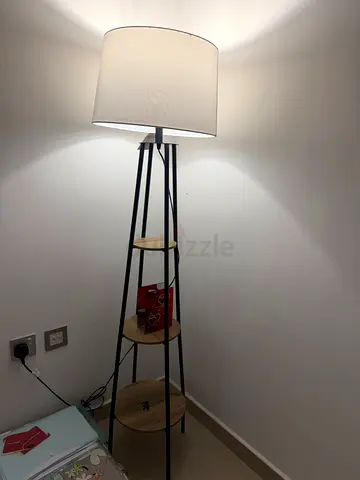 Tall floor lamp with 3-tier wooden shelves and white drum shade