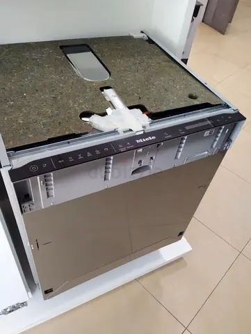 Miele fully integrated dishwasher, likely from the G 7000 series, featuring a specific AutoDos syste