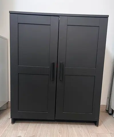 Dark grey two-door storage cabinet / wardrobe - compact