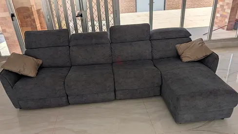 L-shaped grey fabric reclining sofa with chaise lounge - good condition