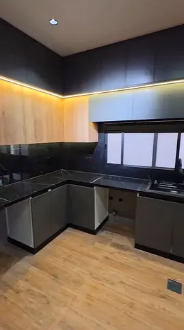 Modern U-shaped Kitchen Cabinets with Black Marble Countertop.