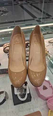 Christian Louboutin Patent Leather Pumps in Nude