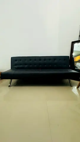 Black faux leather convertible sofa/bed - good condition