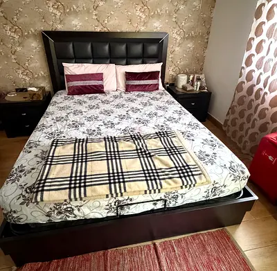 Queen bed with hydraulic storage, medicated  mattress and two bedside tables.
