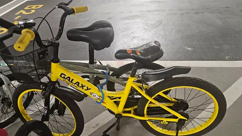 Yellow Galaxy kids/teen bicycle with basket — good working condition, size 22