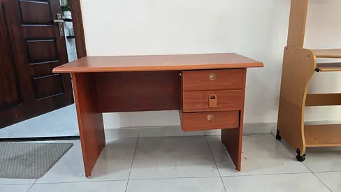 Simple wooden office desk with two drawers — good condition