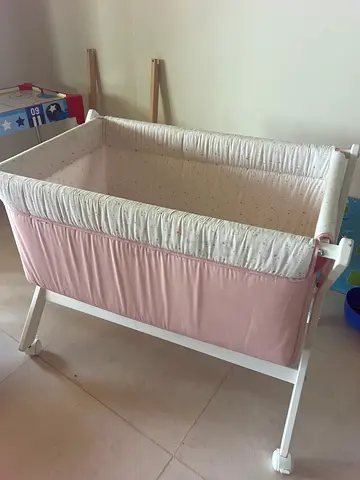 White wooden baby bassinet / cradle with pink liner - good condition