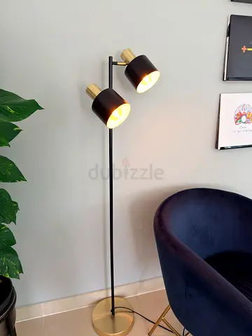 Modern black and brass double-head floor lamp from New Zealand.