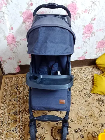 Compact grey baby stroller in good condition