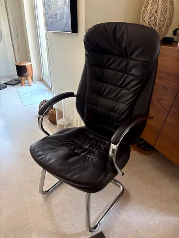 Brown leather office visitor chair with silver  frame.