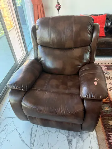 Large Brown Leather Recliner Armchair - Comfortable Used Condition with a remote control