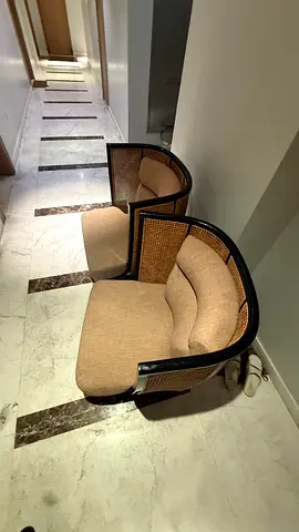 Two pairs of cushioned rattan-back dining chairs — dark wood frame