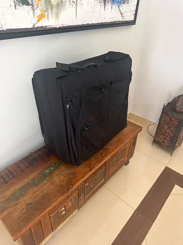 Large TUMI black roller luggage / suitcase in good condition - folding hangers carrier.