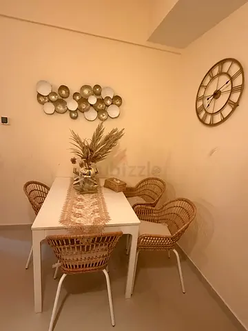 Small white dining table with wicker chairs — set of 4