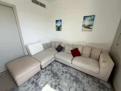 Light grey L-shaped corner sofa with ottoman Comfortable 4-seater office chair for free with carpet