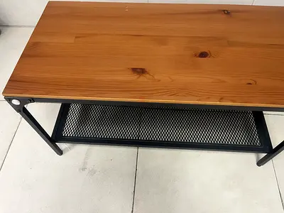 Small wooden coffee table with metal frame and lower mesh shelf