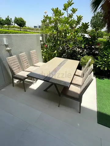 Indoor dining table with six cushioned chairs — good condition