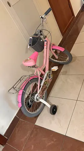 Pink childrens bike with training wheels - good condition