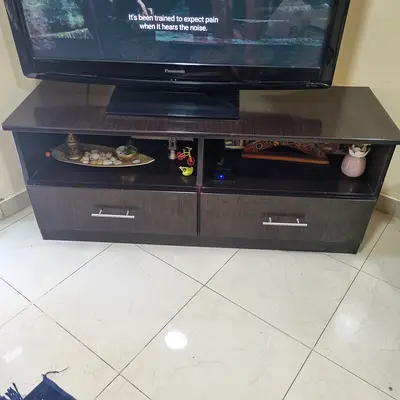 Dark wood TV cabinet with storage drawers