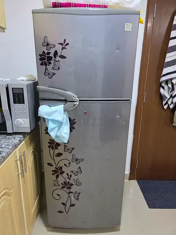 Silver double-door refrigerator with floral design - good working condition