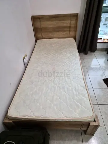 Three new hardly used single wooden cots with mattress