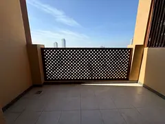 Spacious two-bedroom apartment with a living room, first occupancy, in the Al Nakheel area, next to