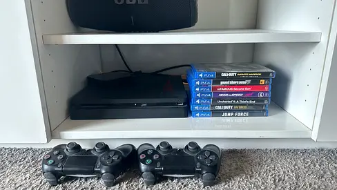 PlayStation 4 Slim with 2 Controllers and 7 Games