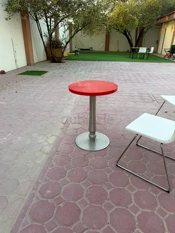 Compact red round cafe table with metal base