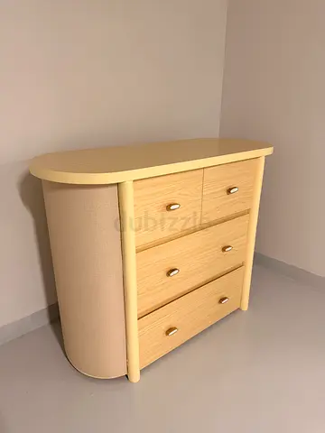 Light wood bedside table with 3 drawers and curved front