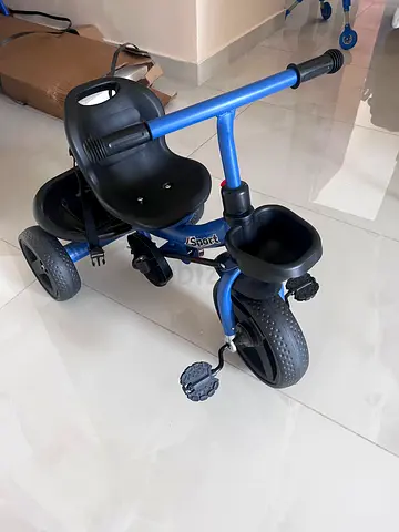 Blue toddler tricycle with parent push handle - good condition