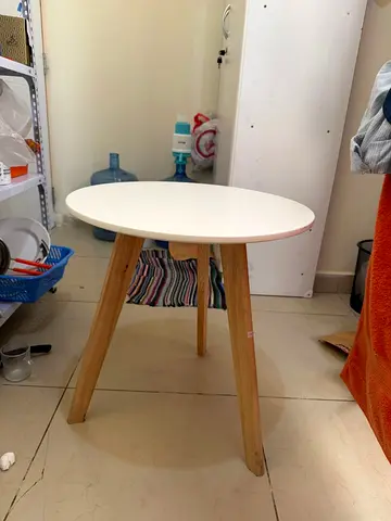 Small round wooden side table with white top